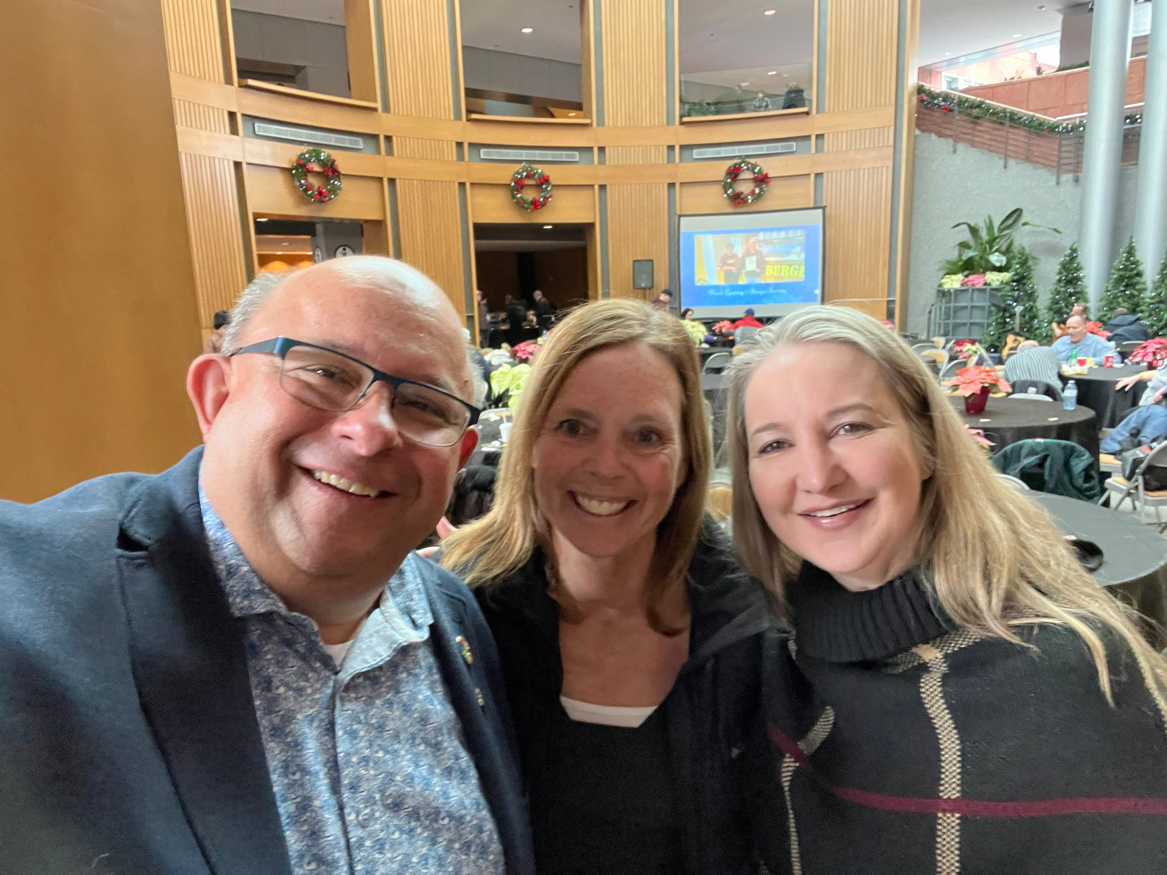 Three people at a Christmas community event